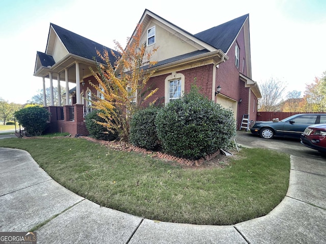 view of home's exterior featuring a lawn and a garage