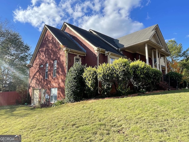 view of side of property with a lawn