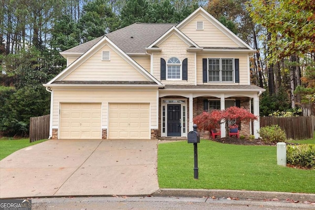 view of front of home featuring covered porch, a garage, and a front lawn