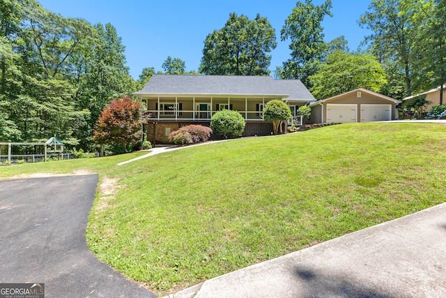 single story home featuring an outdoor structure, a porch, a front yard, and a garage