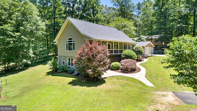 view of front of property with a porch, an outbuilding, and a front yard