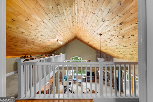 hallway with carpet, wooden ceiling, and vaulted ceiling