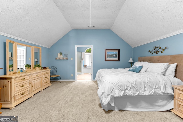 bedroom featuring light carpet, ensuite bathroom, vaulted ceiling, and multiple windows