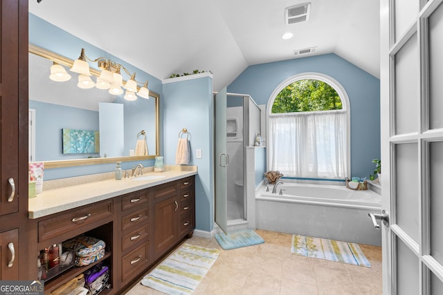 bathroom featuring plus walk in shower, vanity, tile patterned floors, and lofted ceiling