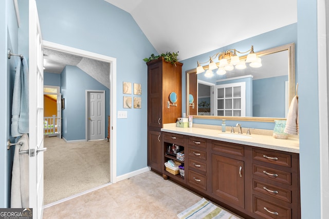 bathroom with vanity and vaulted ceiling