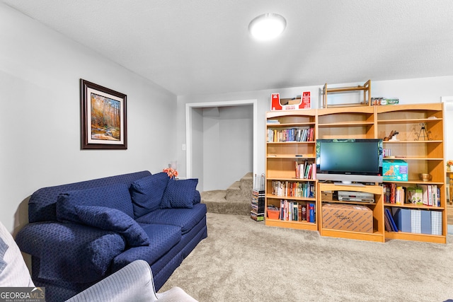 carpeted living room featuring a textured ceiling