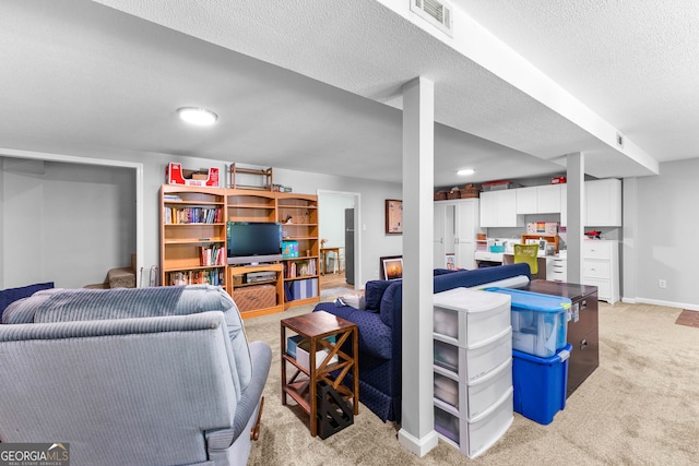 living room featuring light carpet and a textured ceiling