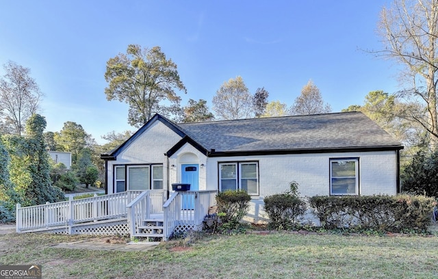 ranch-style home featuring a front yard and a deck