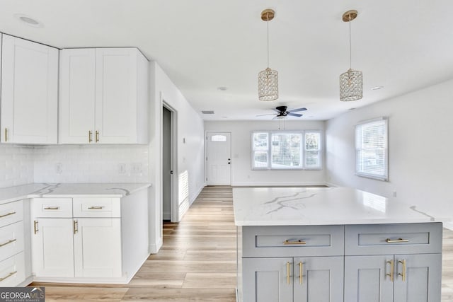 kitchen featuring white cabinetry, pendant lighting, and gray cabinetry