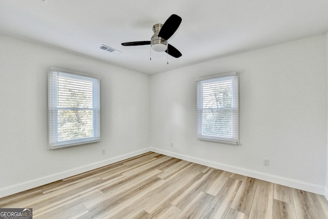 unfurnished room with ceiling fan, a healthy amount of sunlight, and light hardwood / wood-style floors