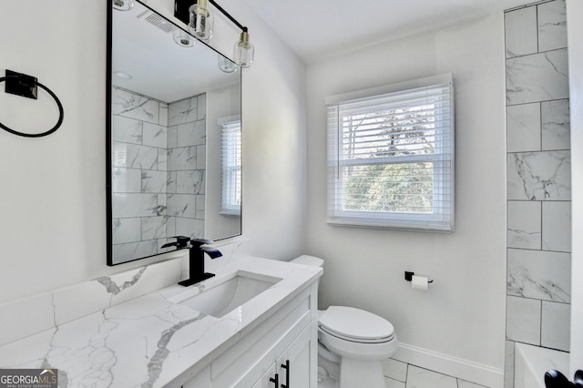 full bathroom with tiled shower / bath combo, vanity, and toilet