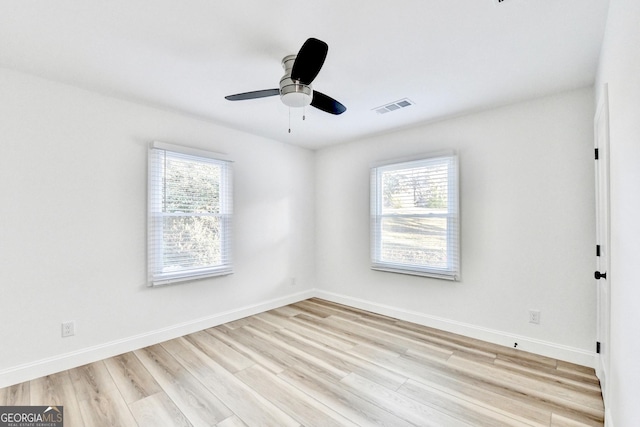 unfurnished room featuring ceiling fan, a healthy amount of sunlight, and light wood-type flooring