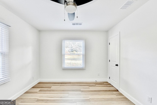 empty room featuring ceiling fan and light wood-type flooring