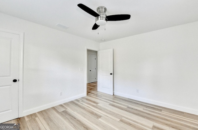 spare room featuring ceiling fan and light hardwood / wood-style flooring