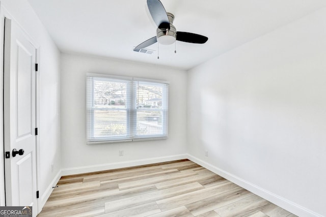 spare room with ceiling fan and light wood-type flooring