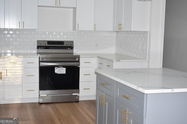 kitchen featuring electric stove, light stone counters, dark hardwood / wood-style flooring, and tasteful backsplash