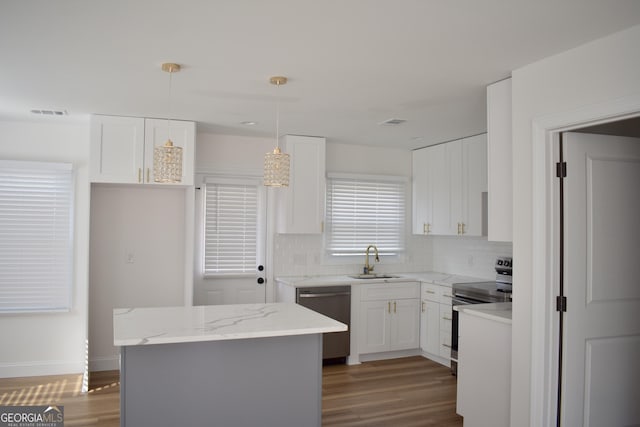 kitchen with sink, stainless steel range with electric cooktop, decorative light fixtures, black dishwasher, and white cabinets