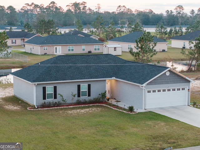 view of front of property featuring a yard and a garage