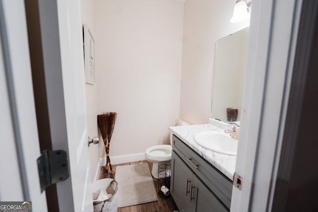 bathroom with vanity, hardwood / wood-style flooring, and toilet