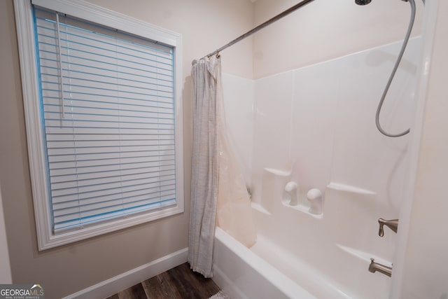 bathroom with shower / bath combination with curtain and hardwood / wood-style flooring