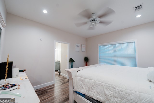 bedroom with connected bathroom, dark hardwood / wood-style floors, and ceiling fan