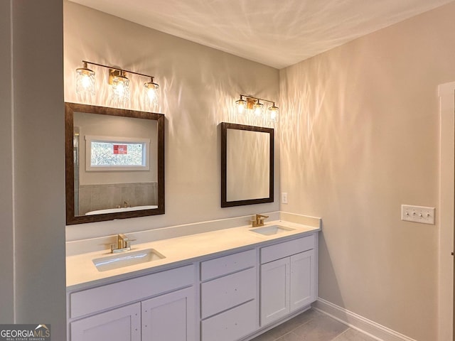 bathroom featuring tile patterned flooring, vanity, and a tub