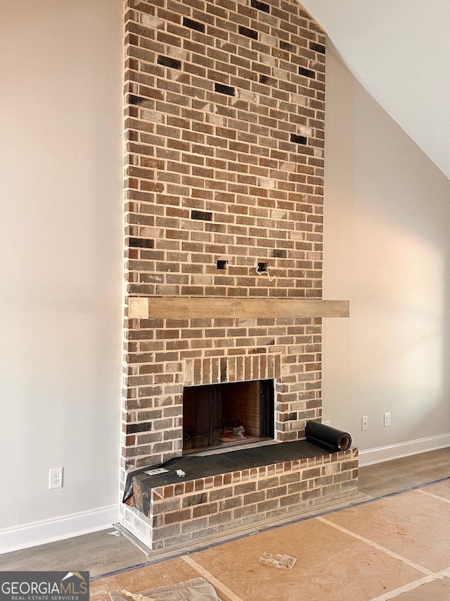 interior details with a brick fireplace