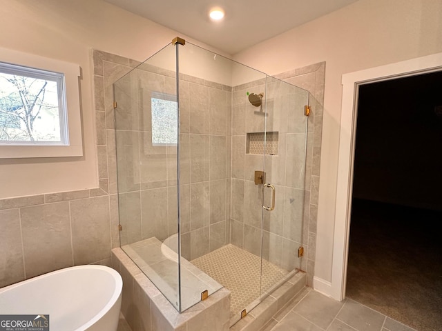 bathroom featuring plus walk in shower and tile patterned floors