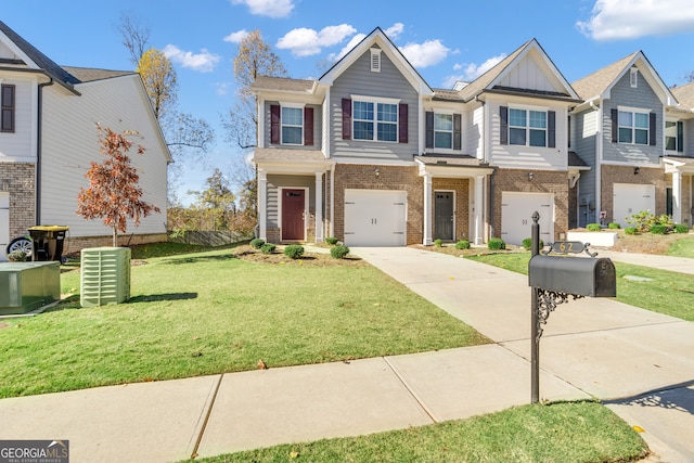 multi unit property featuring a garage, a front lawn, and central air condition unit