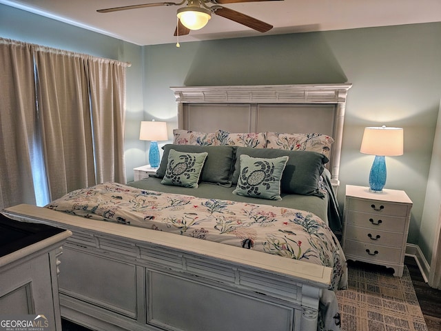 bedroom with ceiling fan and dark wood-type flooring