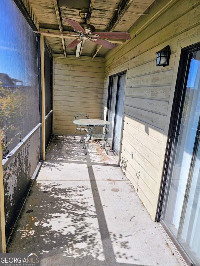 unfurnished sunroom featuring ceiling fan