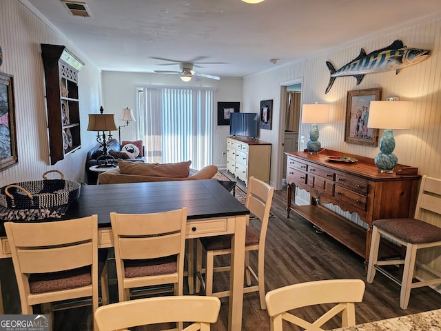 dining room featuring dark hardwood / wood-style floors, ceiling fan, and crown molding