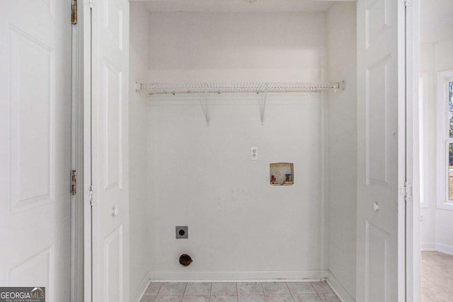 laundry area featuring hookup for an electric dryer, light tile patterned floors, and washer hookup