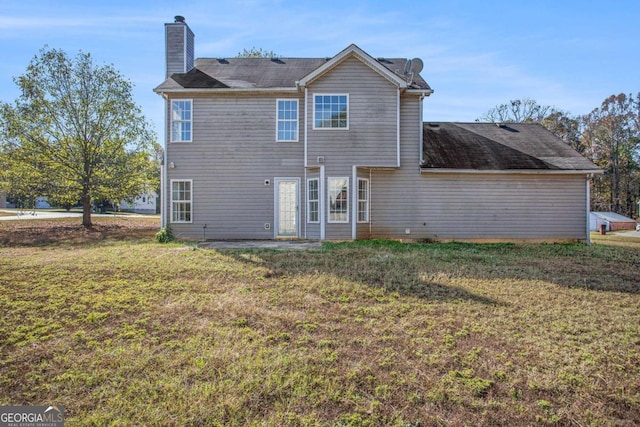 rear view of property featuring a yard