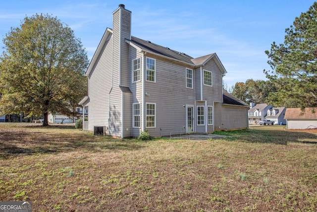 rear view of house with a yard