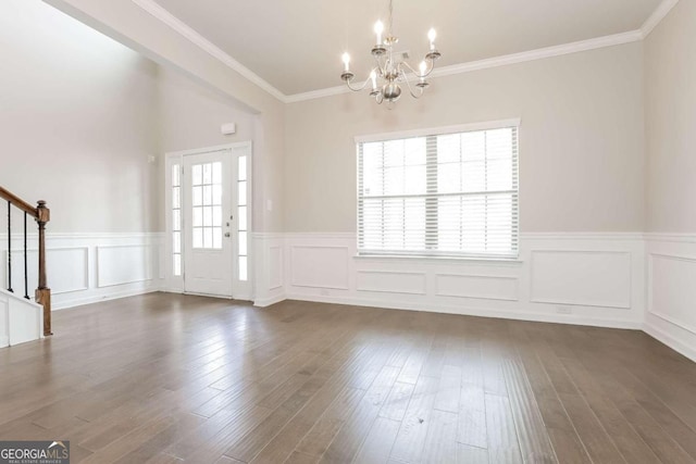 interior space with ornamental molding, dark wood-type flooring, and a notable chandelier