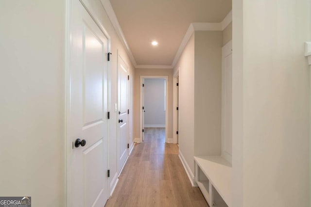 corridor featuring light hardwood / wood-style flooring and ornamental molding