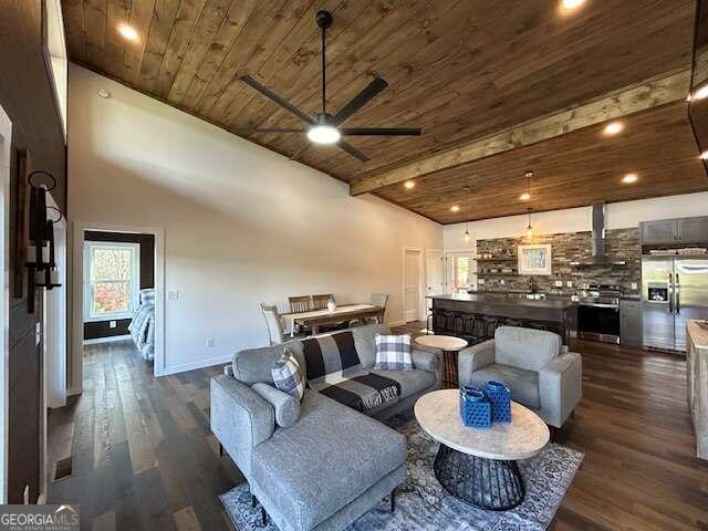 living room with ceiling fan, wooden ceiling, dark wood-type flooring, and lofted ceiling