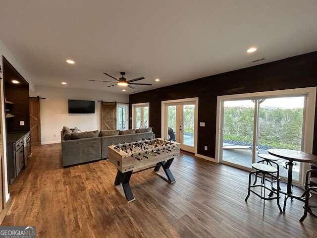 recreation room with french doors, ceiling fan, and wood-type flooring