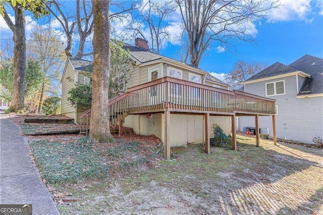 view of home's exterior featuring a wooden deck