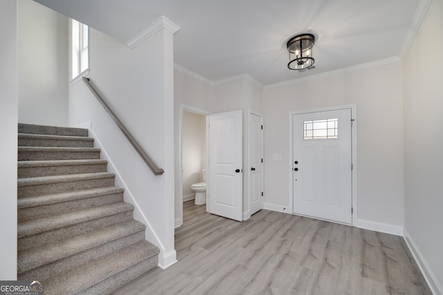 entrance foyer featuring light wood-type flooring and crown molding