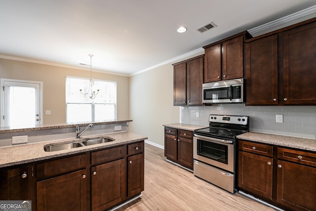 kitchen featuring sink, stainless steel appliances, a notable chandelier, dark brown cabinets, and light wood-type flooring