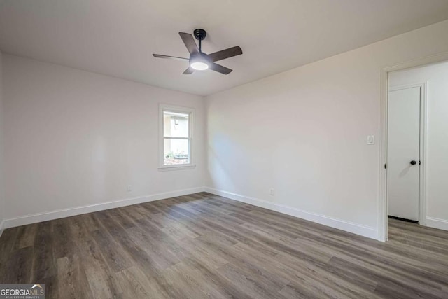 unfurnished room featuring hardwood / wood-style flooring and ceiling fan