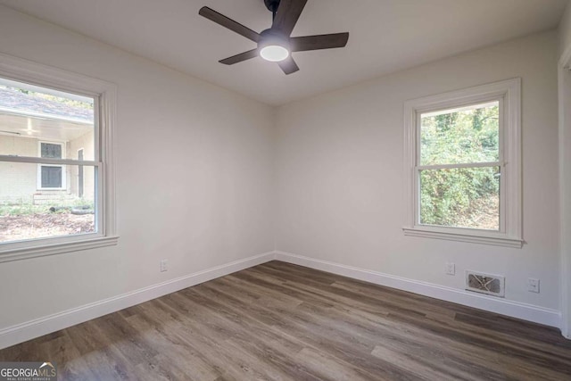 unfurnished room with dark hardwood / wood-style floors and ceiling fan