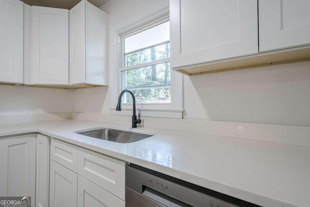 kitchen featuring sink, white cabinets, and stainless steel dishwasher