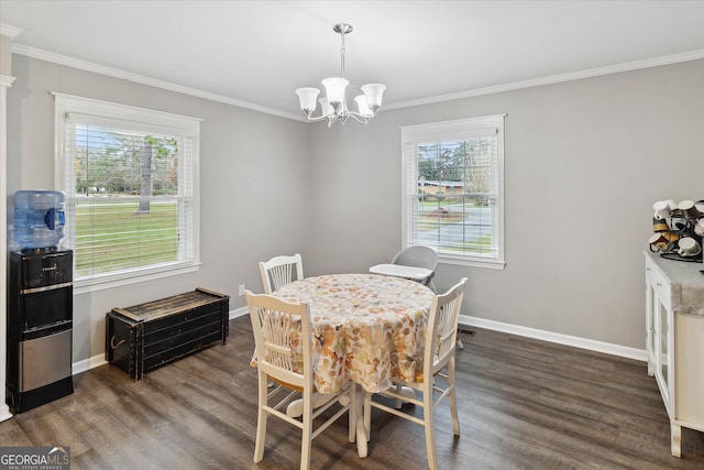 dining space featuring dark hardwood / wood-style floors, a wealth of natural light, and crown molding