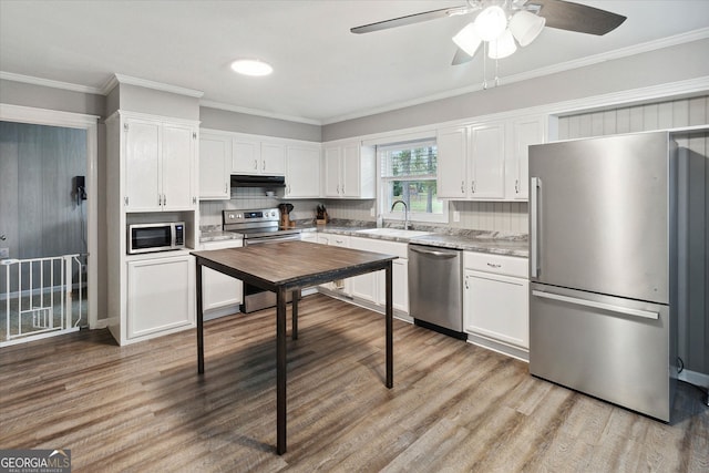 kitchen featuring white cabinets, stainless steel appliances, light hardwood / wood-style flooring, and exhaust hood