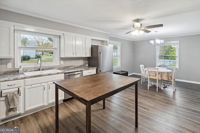 kitchen featuring plenty of natural light, white cabinets, stainless steel appliances, and sink