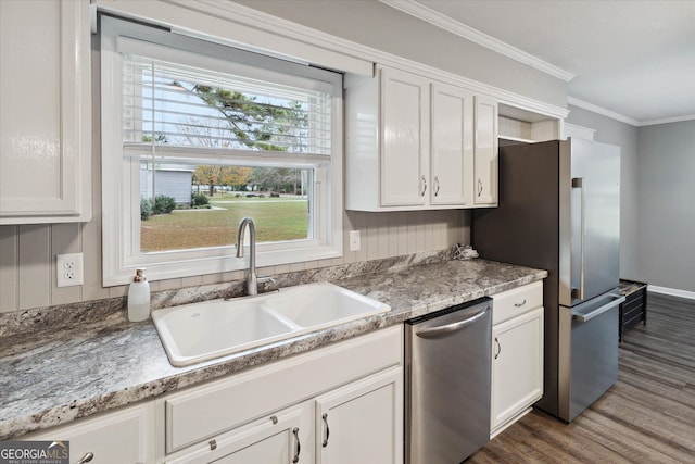 kitchen with crown molding, sink, dark hardwood / wood-style flooring, white cabinetry, and stainless steel appliances