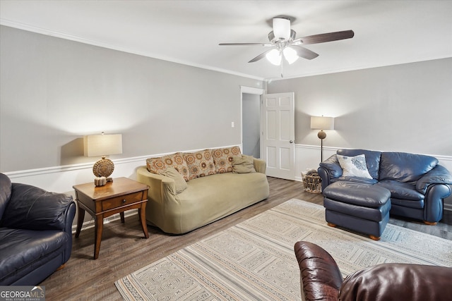 living room with hardwood / wood-style floors, ceiling fan, and crown molding